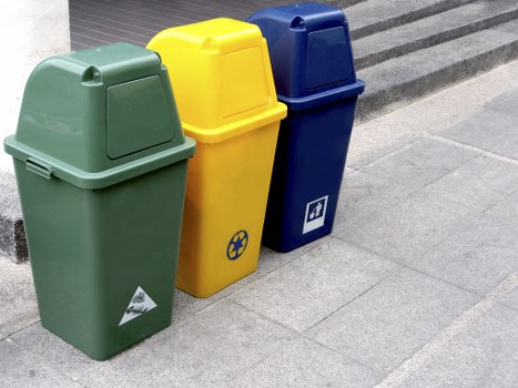 Empty commercial waste containers staged and secured for collection